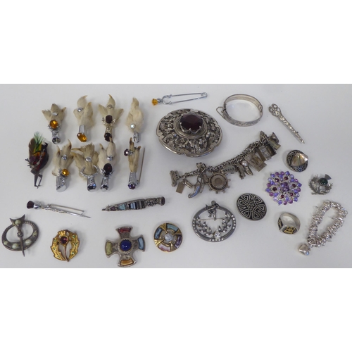 63 - White metal costume jewellery, mainly Scottish: to include a plaid brooch, set with a smoky coloured... 