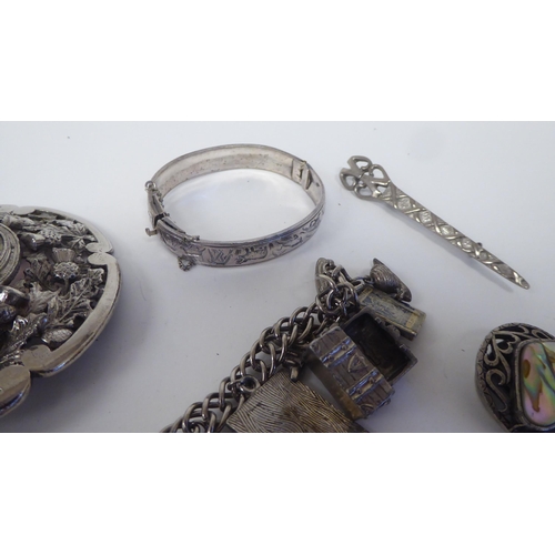 63 - White metal costume jewellery, mainly Scottish: to include a plaid brooch, set with a smoky coloured... 