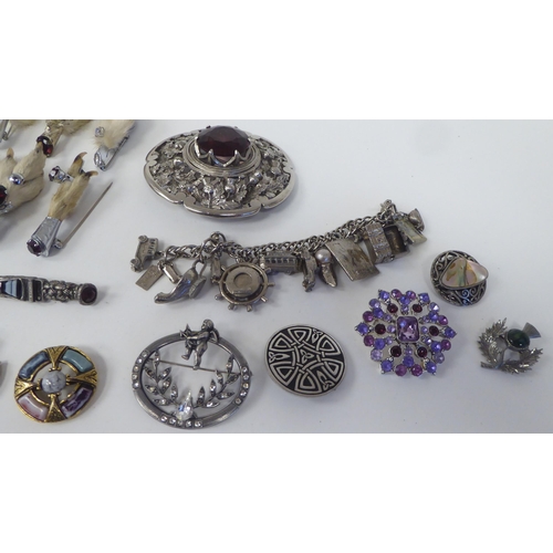 63 - White metal costume jewellery, mainly Scottish: to include a plaid brooch, set with a smoky coloured... 