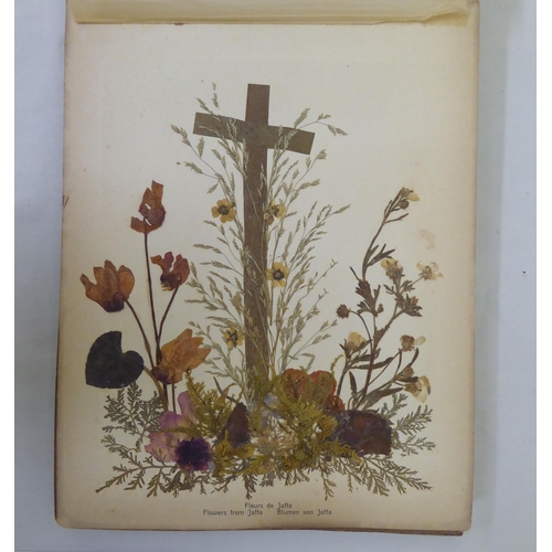 72 - An early 20thC olivewood bound book 'Photographs and Flowers of Hl.Land', featuring dried and presse... 