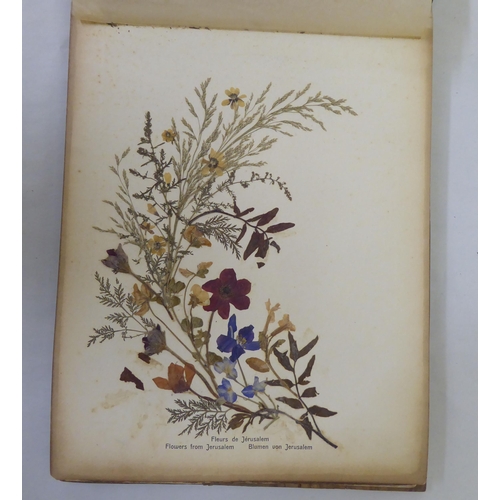 72 - An early 20thC olivewood bound book 'Photographs and Flowers of Hl.Land', featuring dried and presse... 