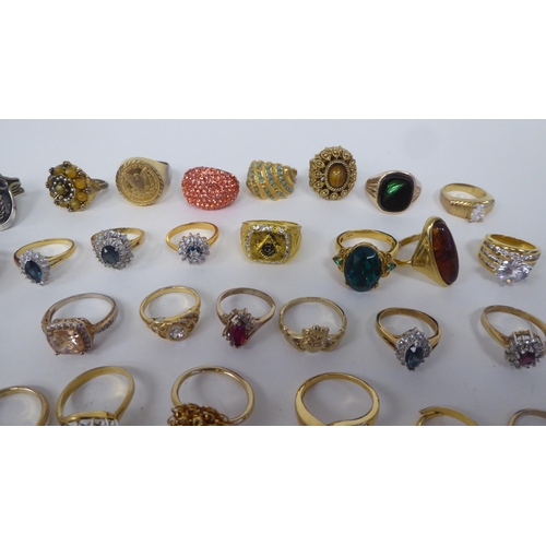 8 - Signet style and other dress rings in white and yellow metal, variously set with coloured stones&nbs... 