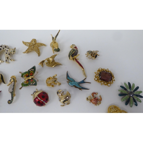 88 - Costume jewellery, mainly brooches, variously set with coloured stones and glass ornament 