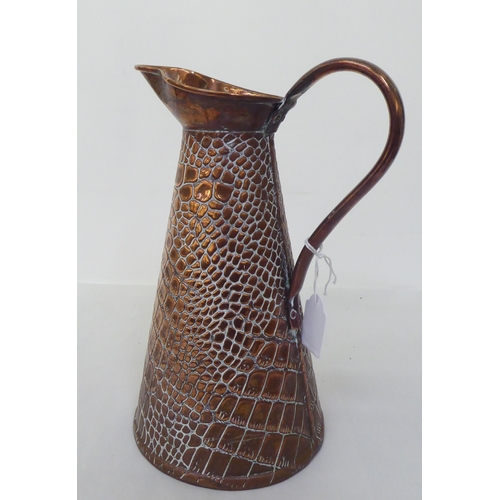 98 - Decorative metalware: to include a 1920s copper jug by Joseph Sankey & Sons  11.5