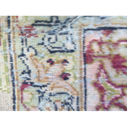 99 - A Persian rug with floral motifs, on a beige ground  70