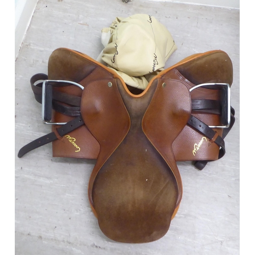 132 - Equestrian accessories: to include a saddle and horse blanket