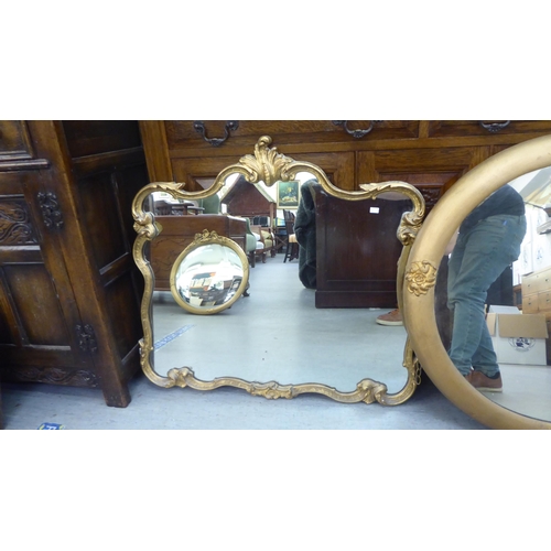 203 - Mirrors: to include an early 20thC example, in a gilt gesso frame with rosette ornament