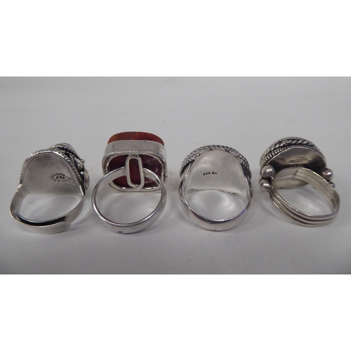 130 - Five dissimilar, variously set, silver coloured metal and other dress rings