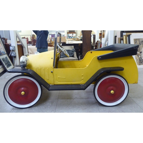 143 - A child's mid thC metal pedal car, decorated in yellow and black livery  36