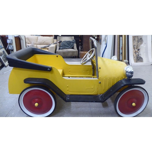 143 - A child's mid thC metal pedal car, decorated in yellow and black livery  36