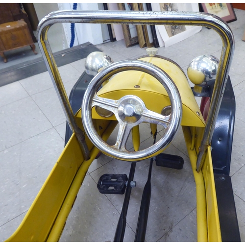 143 - A child's mid thC metal pedal car, decorated in yellow and black livery  36