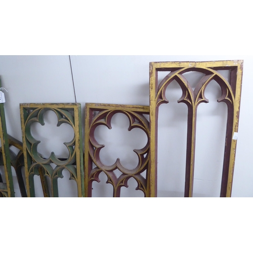 144 - Early 20thC Gothic inspired, painted and carved wooden tracery window panels  largest 57