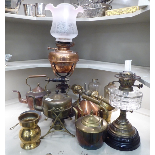 169 - Copper and brass items: to include an oil lamp, raised on turned wooden stand  25