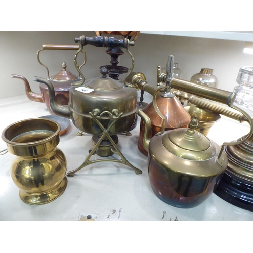 169 - Copper and brass items: to include an oil lamp, raised on turned wooden stand  25