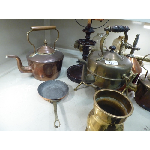 169 - Copper and brass items: to include an oil lamp, raised on turned wooden stand  25