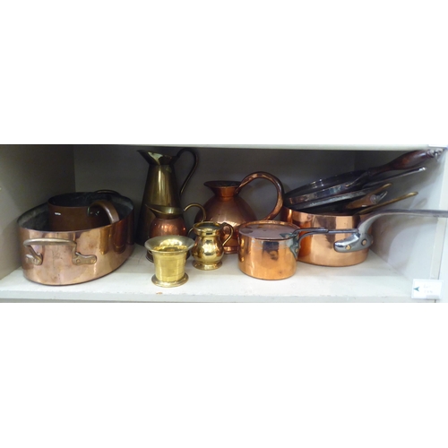 174 - Copper and brass items: to include measuring jugs; pots; and pans