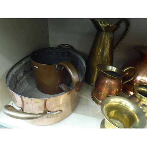 174 - Copper and brass items: to include measuring jugs; pots; and pans