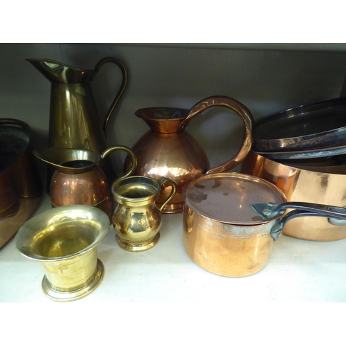 174 - Copper and brass items: to include measuring jugs; pots; and pans