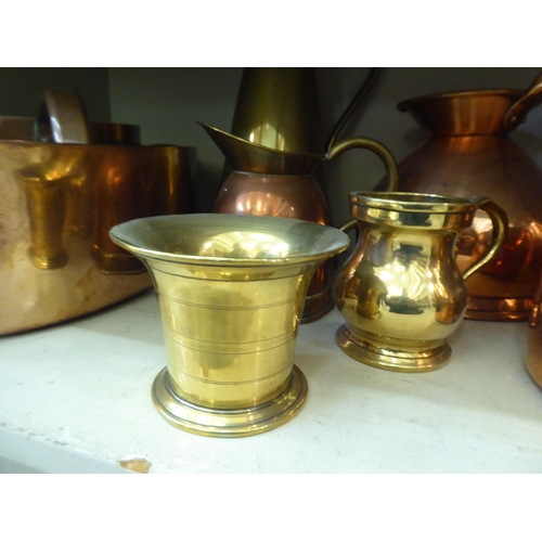 174 - Copper and brass items: to include measuring jugs; pots; and pans