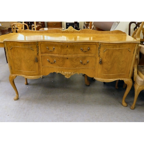 182 - A modern bleached walnut serpentine front sideboard with an arrangement of two drawers/two doors, ra... 