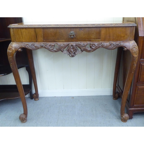 186 - A modern walnut hall table with a frieze drawer, raised on cabriole legs  32