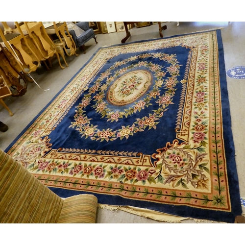 187 - A Chinese washed woollen rug with floral motifs, on a cream coloured ground  105