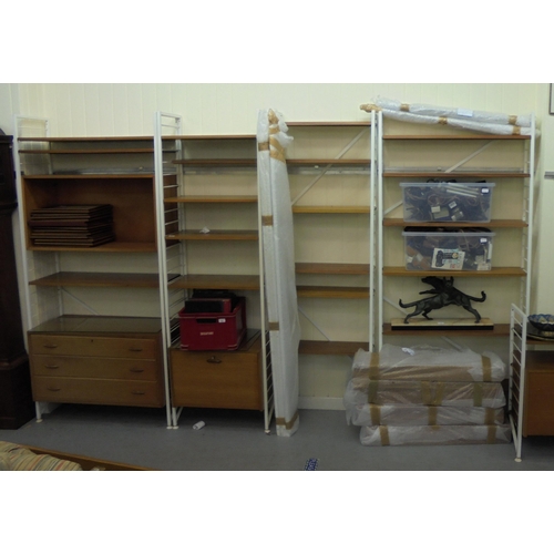 189 - A Ladderax style modular wall unit with teak shelves, cabinets and white painted metal frames, consi... 