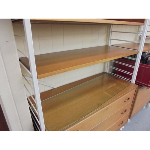 189 - A Ladderax style modular wall unit with teak shelves, cabinets and white painted metal frames, consi... 