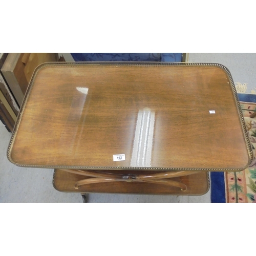 192 - A modern mahogany finished two tier tea trolley, on casters  27