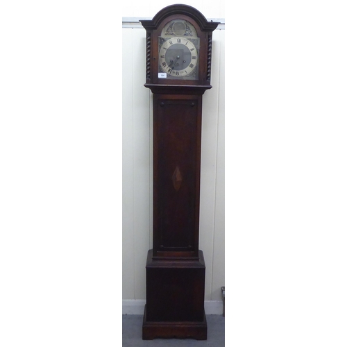 194 - An early 20thC oak cased granddaughter clock, the arched hood decorated with barleytwist columns, co... 