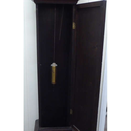 194 - An early 20thC oak cased granddaughter clock, the arched hood decorated with barleytwist columns, co... 