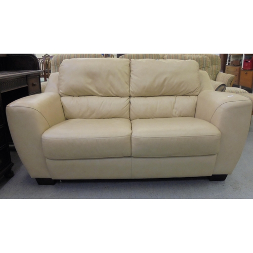 201 - A modern cream hide upholstered two person settee