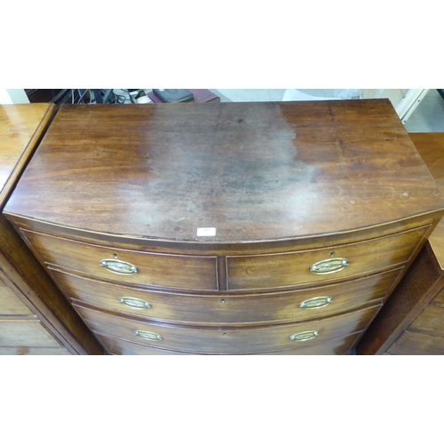 203 - An early 19thC mahogany bow front dressing chest with two short/three long drawers, raised on bracke... 