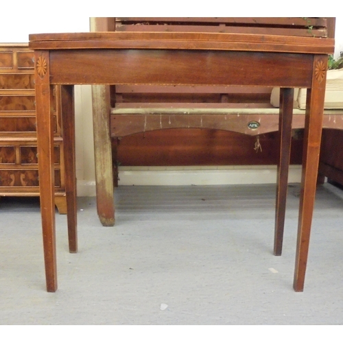 209 - An early 19thC mahogany bow front card table with a foldover top, raised on square legs  29