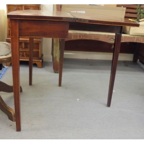 209 - An early 19thC mahogany bow front card table with a foldover top, raised on square legs  29