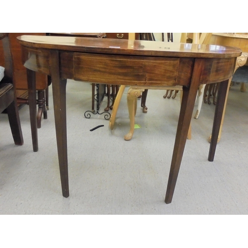 209 - An early 19thC mahogany bow front card table with a foldover top, raised on square legs  29