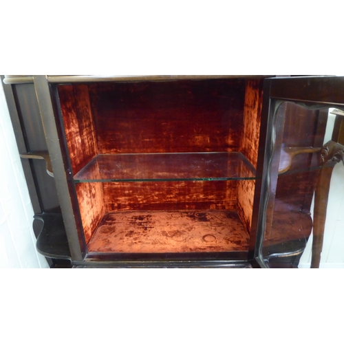 212 - A late Victorian mahogany display cabinet with a glazed door, flanked by open shelves, raised on cab... 