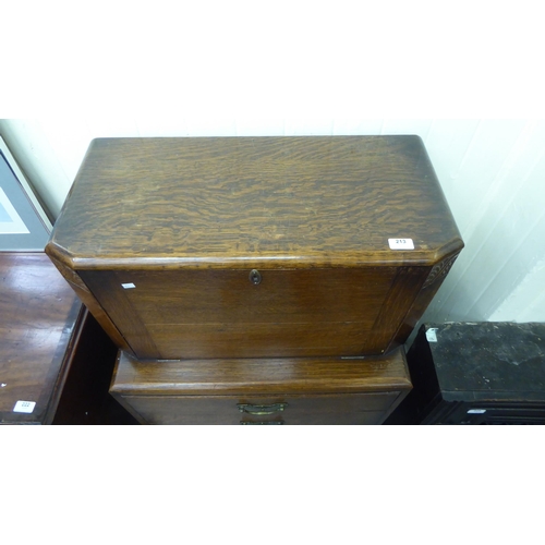 213 - A 1930s oak bureau with a fall front and two drawers, raised on bulbous, turned legs  43