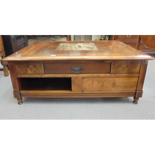 228 - A modern walnut finished coffee table with an arrangement of three drawers, raised on block feet&nbs... 