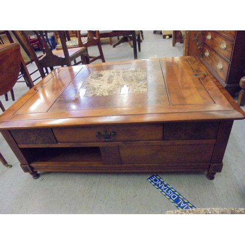 228 - A modern walnut finished coffee table with an arrangement of three drawers, raised on block feet&nbs... 