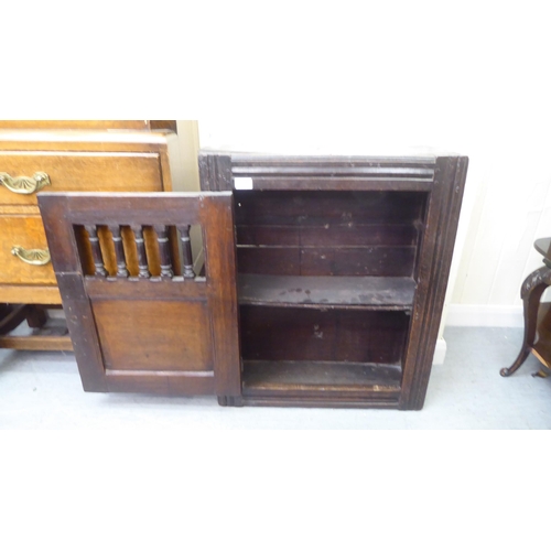 229 - A late 18thC oak wall hanging food cabinet with a single door  29