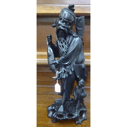 234 - A Japanese carved and lacquered wooden figure, depicting a triumphant fisherman  22