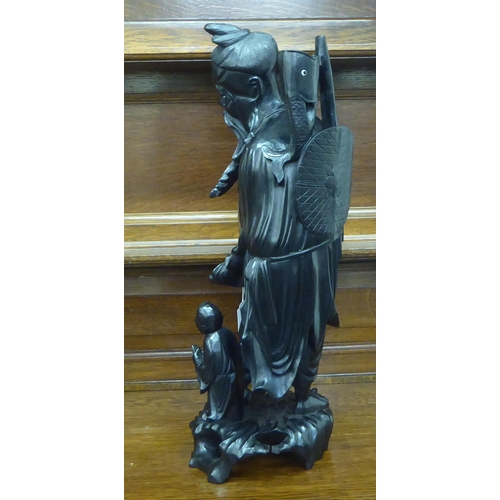 234 - A Japanese carved and lacquered wooden figure, depicting a triumphant fisherman  22