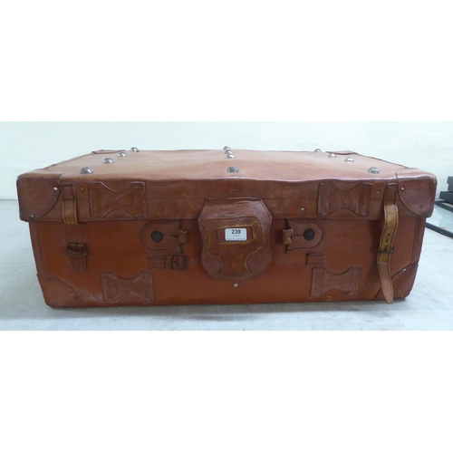 239 - A brown hide case with strap and stud ornament  12