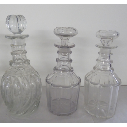 24 - 19thC glass decanters: to include one of wrythen moulded design with a stopper and another etched 'B... 