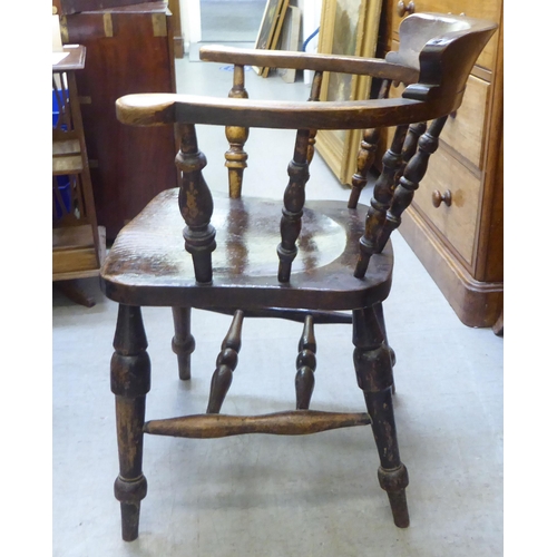 241 - A late 19th/early 20thC beech and oak captains desk chair  bears reference to one Captain Terri... 