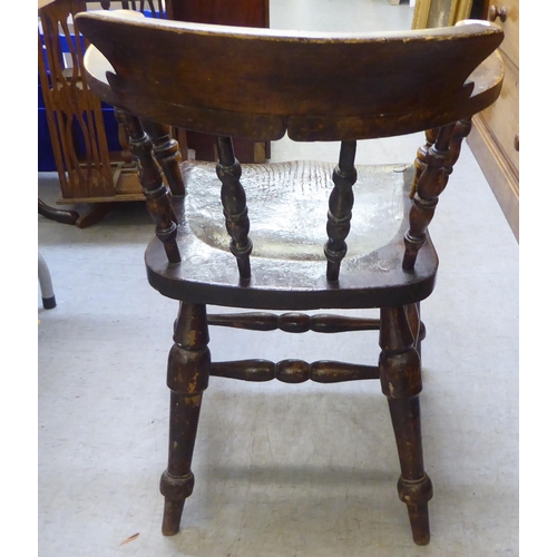 241 - A late 19th/early 20thC beech and oak captains desk chair  bears reference to one Captain Terri... 