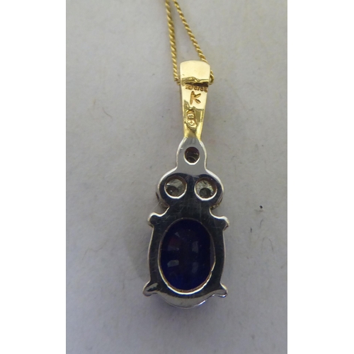 250 - A claw set blue stone and diamond 9ct bi-coloured gold pendant, on a fine neckchain