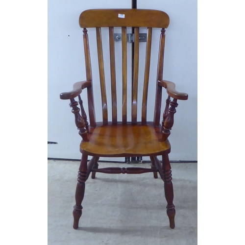 259 - A late Victorian lath back chair, raised on turned legs