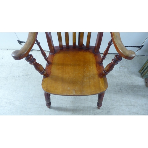 259 - A late Victorian lath back chair, raised on turned legs